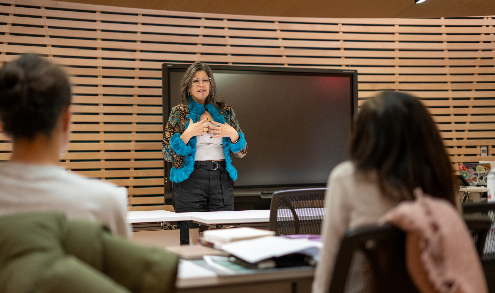 Woman giving a lecture to a class of students